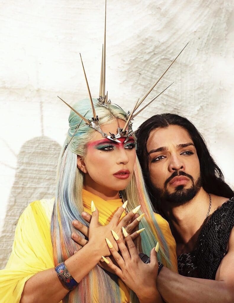 Singer Lady Gaga wearing Lance's mask with a music video extra.