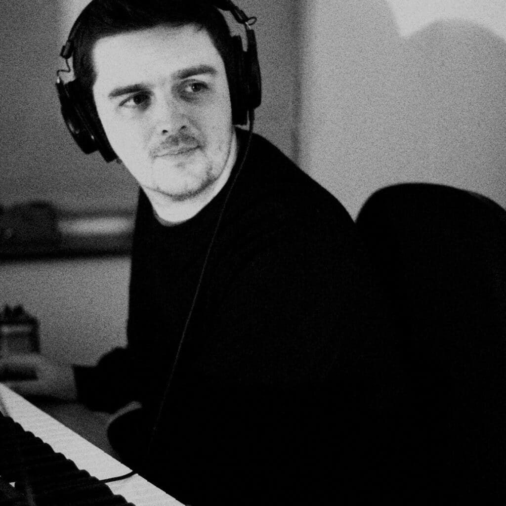 A man with headphones in a music studio.